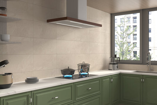 Modern kitchen with green cabinets, white countertops, and a window view.