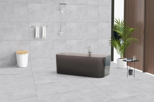 Modern bathroom with a freestanding bathtub, gray tiles, and a plant.